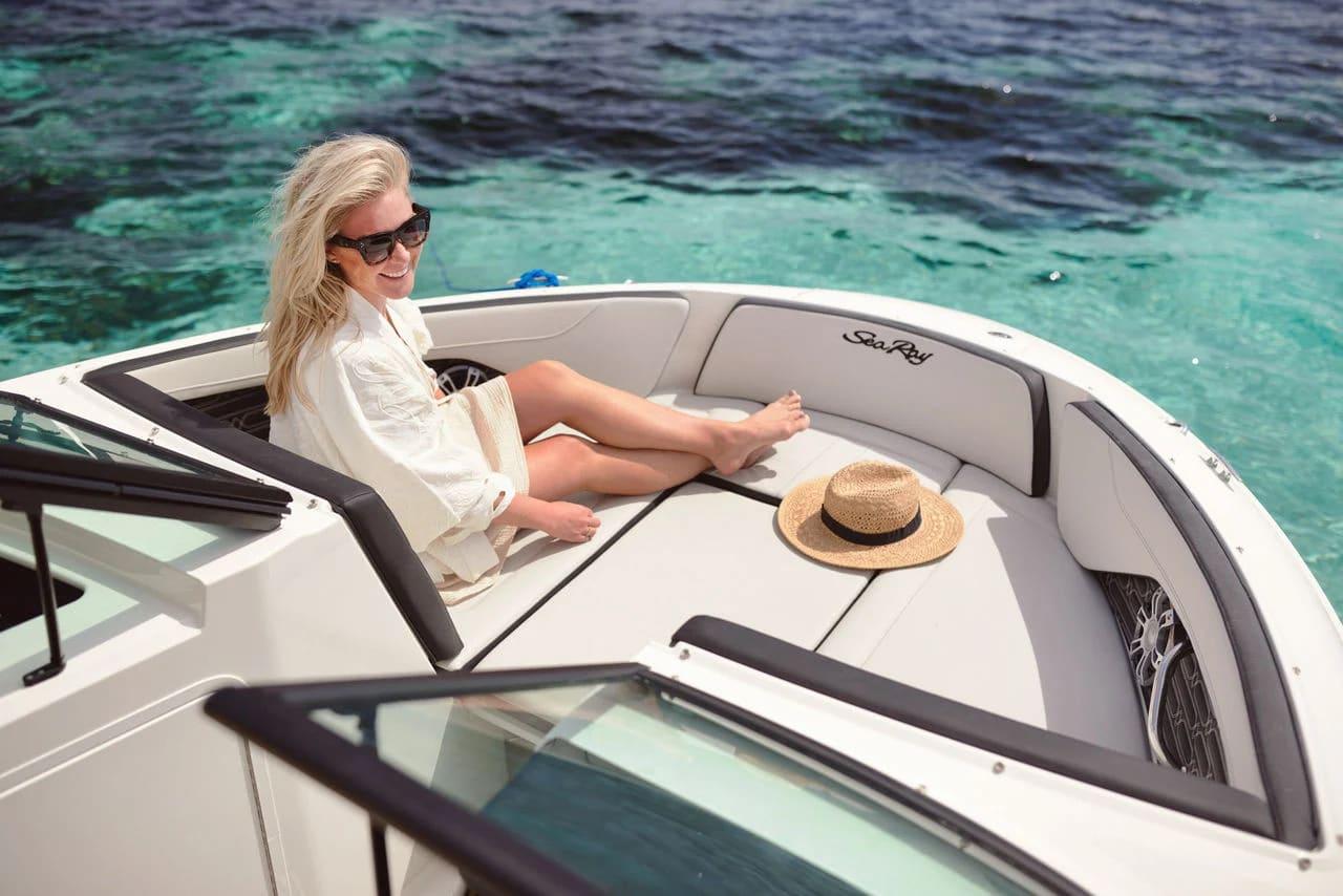 A member reading in the sun on the bow sunpad
