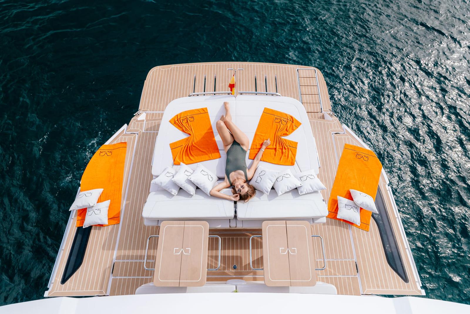 A member sunbathing on the bow sunpad